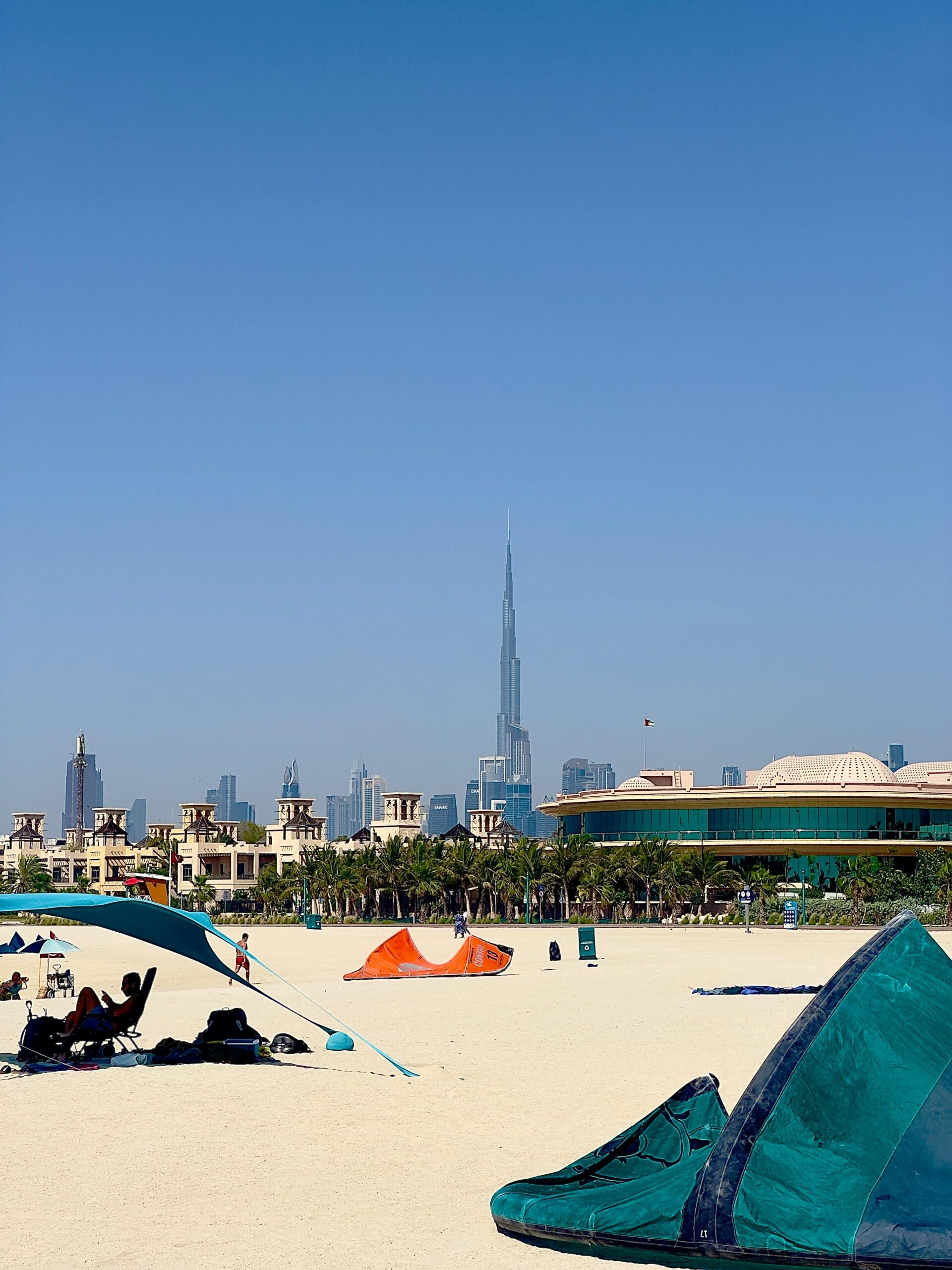 A scenic view of a Dubai beach with Burj Khalifa in the skyline.